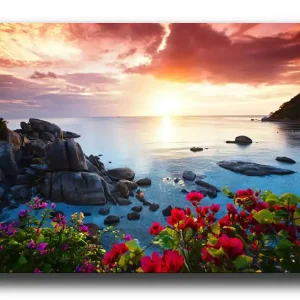 Canvastavla 70x100 cm - Vacker solnedgång över havet med klippor och färgglada blommor i förgrunden Rosa / Blå / Orange - Inredning Sista chansen