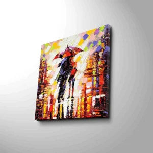 Canvastavla 45x45 cm - Silhuett av en person med paraply i en färgglad stadsmiljö Röd / Orange / Svart - Inredning Nedsatt pris