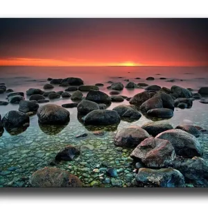 Canvastavla 70x100 cm - Stillsam strand med klippblock som speglar en vacker solnedgång vid horisonten Mörkgrå / Grön / Orange - Inredning Erbjudande