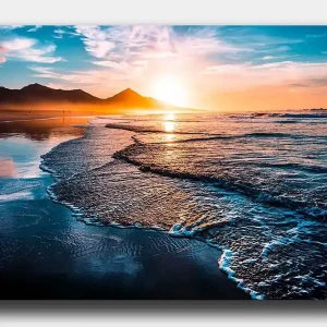 Canvastavla 70x100 cm - Solnedgång över en strand med mjuka vågor som rullar in mot kusten Blå / Orange / Turkos - Inredning Populär